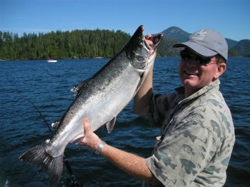 Tom Of Utah with one of his Coho landed at Pill Point in Barkley Sound located on Vancouver Island British Columbia.  tom had a fascinating Fall Day with family and fished with guide Doug of Slivers Charters Salmon Sport Fishing