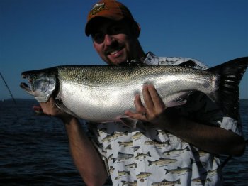 Paul with a great bright silver Coho caught using a green hootchie at ecoole in Barkley Sound.  Paul fished with wife Kim and Father Tom with guide Doug of Slivers Charters Salmon Sport Fishing