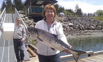 Linda is all smiles as she shows her Chinook Salmon which was picked up on the lighthouse bank using a coyote spoon in four inch size known as blue-nickel.   Many of the early run chinook have been from thirteen to twenty pounds