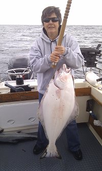 Nancy and her twenty-five pound halibut picked up at the inner south bank outside of Ucluelet using a iridescent Turd at 130 feet.  Guide was Al.