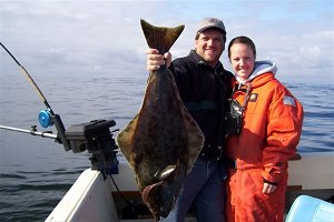This is Jonathan Yoder from Vancouver B.C. with his companion who had a great day out at South Bank  which is fourteen miles offshore from Ucluelet. This is a fourteen pound Halibut which hit anchovy.  Jonathan and his friend fished with Mike Marriott from Ucluelet.  Besides this Halibut three Chinook from 14 to 17 pounds were landed.
