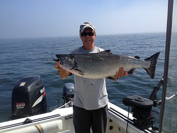 Doug of Slivers Charters Salmon Sport Fishing with twenty-three pound Chinook. Chinook salmon migrating down offshore Vancouver Island are in big numbers. The Columbia system this year has said 1.2 million Chinook returned to their system