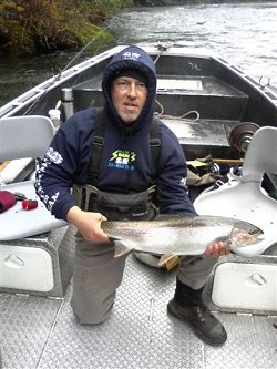 Guest from Seattle Washington shows off his summer Steelhead picked up in the Upper Stamp River which is close to Port Alberni Vancouver Island.  Fish was anded using red wool.