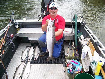 Guide Nick displays six Coho landed by Florida guests recently fishing the Stamp River