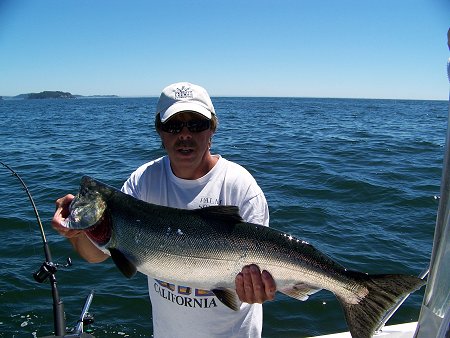 Doug of Slivers Charters Salmon Sport Fishing with 22 pound Chinook caught between Meares and Austin Island Barkley Sound by guest Frank of Phoenix Arizona.  Great fishing on surfline and just offshore of Vancouver Island B.C.