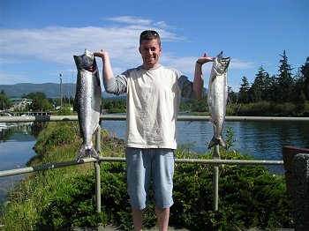 Tyler shows off two fish he caught in Barkley Sound close to Swale Rock. Tyler is at the Clutesi Haven Marina in this picture on the Somass River at the marina cleaning station.