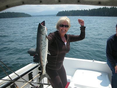 This is a picture of Arlene with first ever salmon.  She was very excited  and picked this Chinook at Kirby Point   Arlene from Calgary Alberta fished with John of Slivers Charters