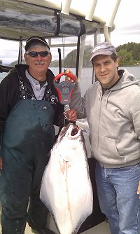 Guide Al on the left and guest Greg of Vancouver B.C. with a forty-five pound halibut landed outside of Ucluelet using a green hootchie as lure.
