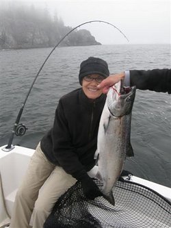 Joanne of Tampa Bay Florida landed this salmon right off of Meares Bluff located on the surf line of Barkley Sound Vancouver Island.  Joanne fishing with Doug of Slivers Charters Salmon Sport fishing landed this fish using a four inch Green-nickel coyote spoon
