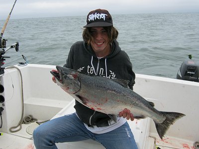 Ashtyn of Saskatoon Saskatchewan shows his 18 pound Chinook caught at Cree Island.   This fish hit a four inch green-nickel coyote spoon.  Ashtyn and family fished with John of Slivers Charters Salmon Sport Fishing.