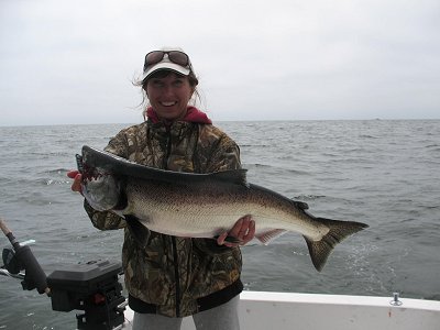 Irena of Russia shows her big Chinook she caught on the Barkley Sound surf line.  This fish was caught on a hootchie and guide was John of Slivers Charters