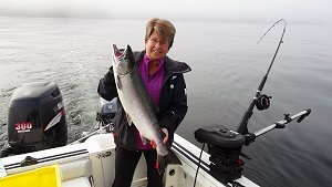Charmayne and husband Brian from Edmonton Alberta fished with Doug of Slivers Charters Salmon Sport Fishing.  This Coho salmon was landed at Yankee Bay located along the Bamfield Wall in Barkley Sound.  The Coho hit a AORL 12 hootchie
