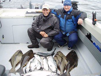 This was a great day for Jari and Arto as they display their catch of halibut and salmon.  These two avid fishermen are from Finland  are coaches of the womens national hockey olympic team from Finland.  Thet fished the Big Bank and were guided by guide Graham.